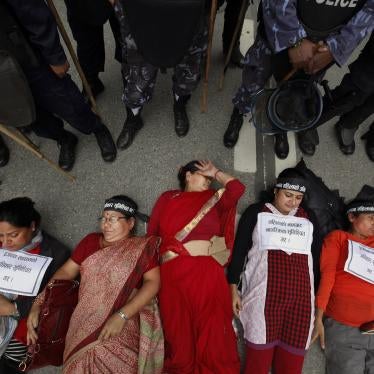 Nepalese women lie on the ground during a protest in Kathmandu