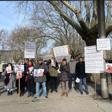 Supporters of Tajik activist Abdullohi Shamsiddin, in Dortmund, Germany, hold posters