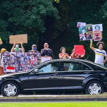 Protesters hold banners and chant slogans during Egyptian President Abdel Fattah al-Sisi’s official visit to Germany on July 18, 2022, in Berlin.