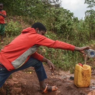 A 16-year-old boy collects water from a spring near Lega Dembi gold mine in the Oromia region of Ethiopia. @2020 Tom Gardner 