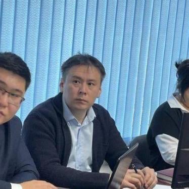 Zhanbolat Mamay, left/center, sits with his lawyers during a trial hearing in November 2022 in Almaty, Kazakhstan.