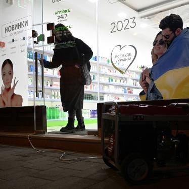 A customer walks out of a drugstore lit by a portable generator during a blackout in the Western Ukrainian city of Lviv following massive Russian airstrikes on January 14, 2023. 