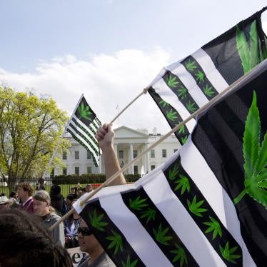 A demonstrator waves a flag during a protest calling for the legalization of marijuana, outside of the White House in Washington, DC, US.