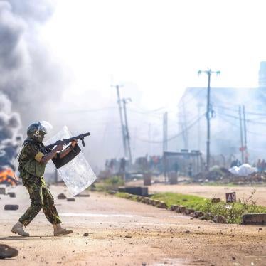A riot police officer fires tear gas at protesters during a mass rally called by the opposition leader Raila Odinga over the high cost of living, in Nairobi, Monday, March 27, 2023. 