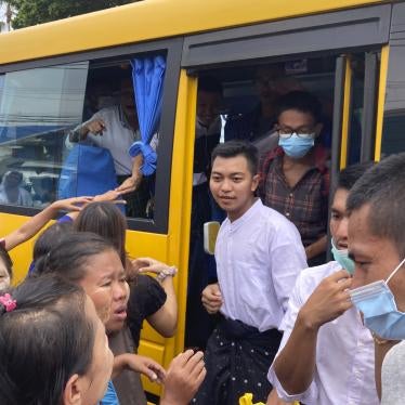 Prisoners get off a bus after their release from Insein Prison