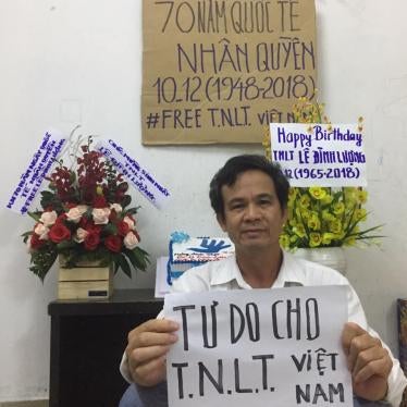 Tran Van Bang holds a sign that says “Freedom for Vietnamese Prisoners of Conscience” to celebrate the 70th anniversary of the Universal Declaration of Human Rights.