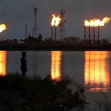 Flames emerge from flare stacks at Nahr Bin Umar oil field, north of Basra, Iraq.