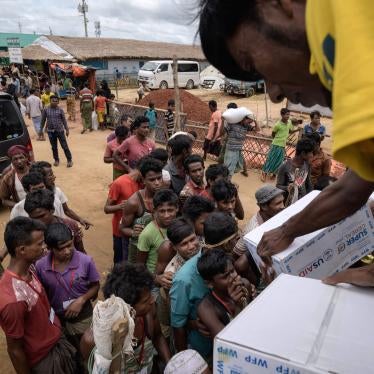 Rohingya refugees collect boxes of food aid at a distribution point in the Kutupalong camp near Cox's Bazar, Bangladesh, August 14, 2018.