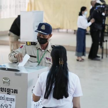 A police officer drops his ballot at a polling station in Takhmau in Kandal province, southeast of Phnom Penh, Cambodia, June 5, 2022.