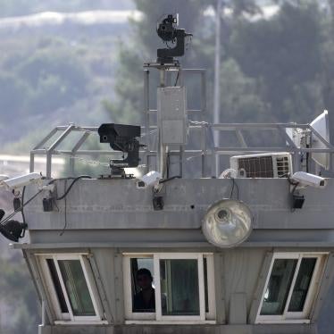 Two guns sit atop a guard tower along with surveillance cameras overlooking the Aroub refugee camp in the Israeli-occupied West Bank, October 6, 2022. 