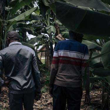 Men stand by a mass grave where five men and boys were allegedly executed by the M23 armed group in November 2022 in Kishishe, eastern Democratic Republic of Congo, April 5, 2023. 