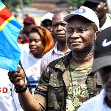A man holds the flag of Democratic Republic of Congo in a march