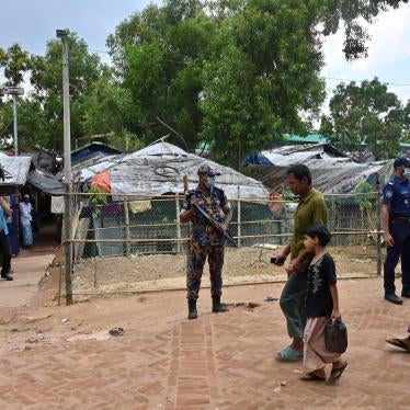  Security force officers stand guard after the killing of Rohingya community leader Mohib Ullah in the Kutupalong refugee camp, Bangladesh, October 2021.