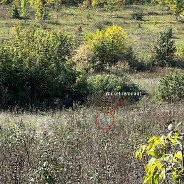 The carrier section of an 9M27K-series Uragan rocket lodged in the ground near a family’s home in Hlynske village, apparently fired from the west, where Ukrainian forces controlled territory while the area was under Russian occupation in 2022.  Each rocket delivers 30 9N210 or 9N235 submunitions.