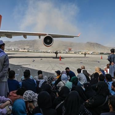 Afghans waiting to leave Afghanistan from Kabul’s international airport after the Taliban takeover, August 16, 2021.