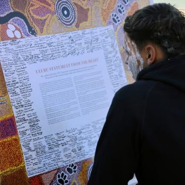 A member of the Gamay Dancers, a group performing in the Dharawal language, studies the Uluru Statement from the Heart, a document calling for an Indigenous Voice to Australia’s parliament, at an event celebrating Indigenous culture in Sydney, July 6, 2023. 