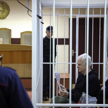 Ales Bialiatski, the head of Belarusian Viasna rights group, centre, sits in a defendants' cage during a court session in Minsk, Belarus, January 5, 2023.