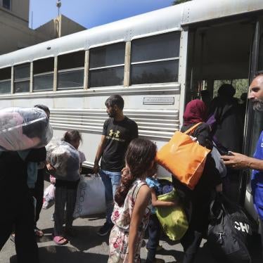 Palestinian residents who fled their houses in the Palestinian refugee camp of Ein el-Hilweh, carry their belongings as they board a bus to be moved from Sidon municipality to an UNRWA (United Nations Relief and Works Agency for Palestine Refugees) school, in the southern port city of Sidon, Lebanon, September 12, 2023. 