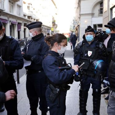 Police officers check IDs of demonstrators near the Palais Vivienne event venue in Paris, France, April 6, 2021.