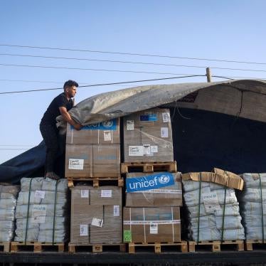 A man unloads humanitarian aid from a convoy of trucks entering the Gaza Strip from Egypt via the Rafah border crossing on October 21, 2023.