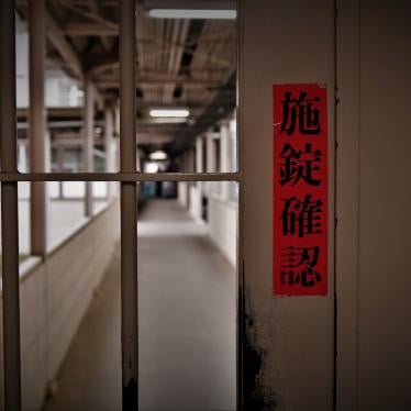 A sign in Japanese reads "check door lock" on a gate inside Tochigi prison