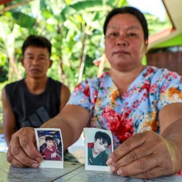 Thawatchai and Thongkoon On-kaew, parents of Natthaporn, hold photos of him outside their home in Nakhon Phanom, Thailand, October 10, 2023. Natthaporn was working in Israel when members of Palestinian armed groups took him hostage on October 7, 2023. 