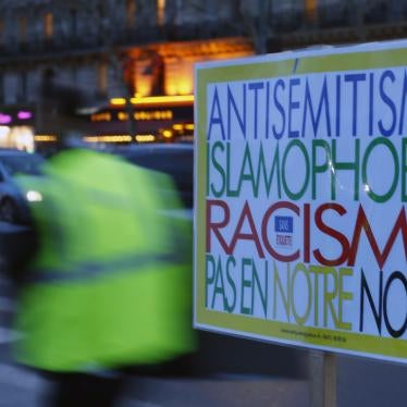 A poster reading "Anti-Semitism, Islamophobia, Racism, Not in Our Name" during a gathering decrying anti-semitism at Place de la Republique in Paris, February 18, 2019.