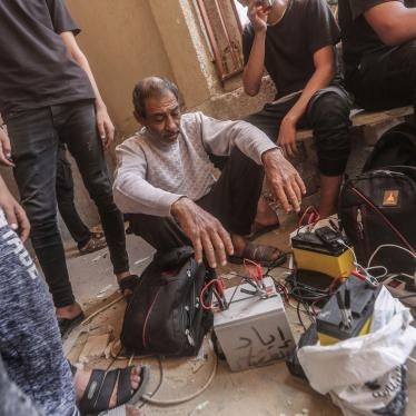 Palestinians in Khan Yunis, Gaza, use car batteries to charge their mobile phones, October 23, 2023.