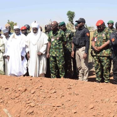 Nigerian Chief of Army Staff Lt. Gen. Taoreed Lagbaja, center, with other community leaders at the grave side where victims of an army drone attack were buried in Tudun Biri village, Nigeria, December 5, 2023.