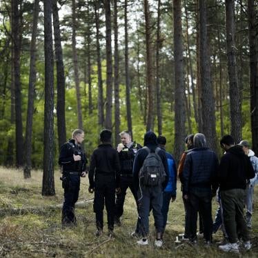 Federal Police officers, on patrol in a forest near Forst south east of Berlin, Germany stand with a group of people who have irregularly crossed the border from Poland into Germany  October 11, 2023