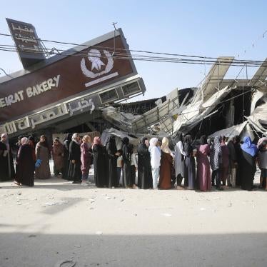 People line up for bread at a partially collapsed but still operational bakehouse in Nuseirat refugee camp in Deir al Balah, Gaza, November 4, 2023.