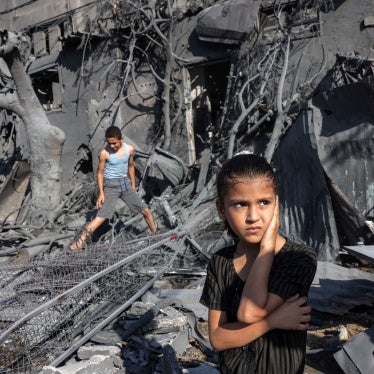 A girl stands by the rubble outside a building hit by Israeli bombardment in Rafah in the southern Gaza Strip on October 31, 2023. 