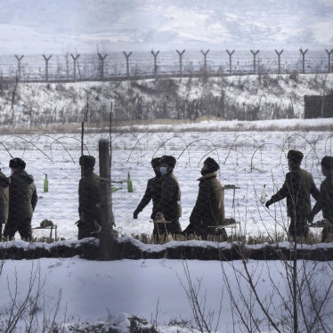 Photo taken on Dec. 22, 2022, from China's Dandong shows North Korean soldiers patrolling on a riverside in the border county of Uiju.