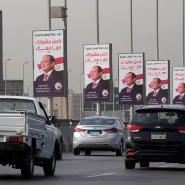 Vehicles pass near banners displaying Egyptian President Abdel Fattah al-Sisi for the presidential elections, in Cairo, Egypt, on December 10, 2023.