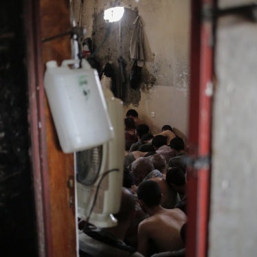 Suspected Islamic State members sit inside a small room in a prison south of Mosul, Iraq, July 18, 2017.