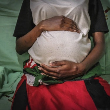 A 19-year-old mother is seen holding her baby bump in Nairobi, Kenya, July 7, 2020. 