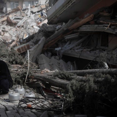 A man beside the rubble of a building in Antakya, southern Türkiye, on March 6, 2023, one month after the devastating earthquakes in which over 50,000 people died and hundreds of thousands were injured and displaced.