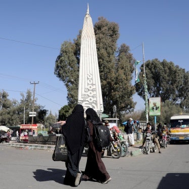 Women walk at the “Change Square” outside Sanaa University’s gate, Sanaa, Yemen. 
