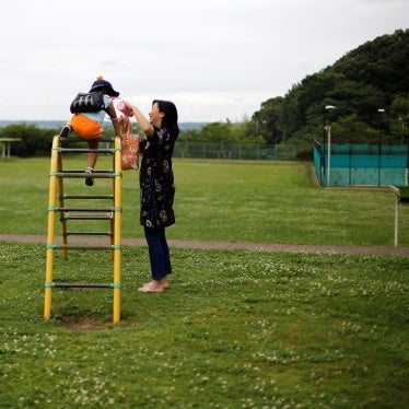 Foster mother Asako Yoshinari and her foster child at a park near her home in Inzai, Chiba prefecture, Japan, June 24, 2016.