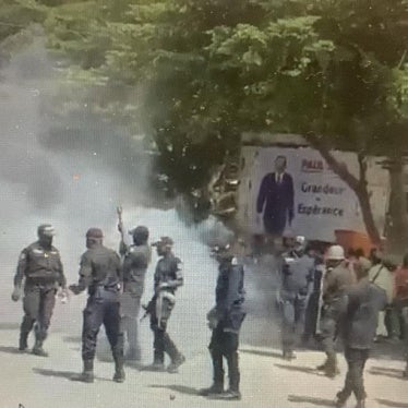 Police surrounded by clouds of tear gas