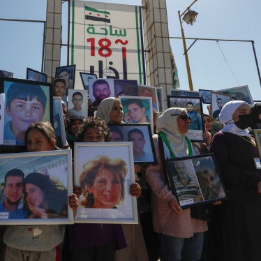 Family members hold pictures of their relatives who disappeared in the nearly 14-year Syrian conflict, during a protest calling on the interim government to not give up on efforts to find them, in the city of Daraa, Syria, March 16, 2025. 