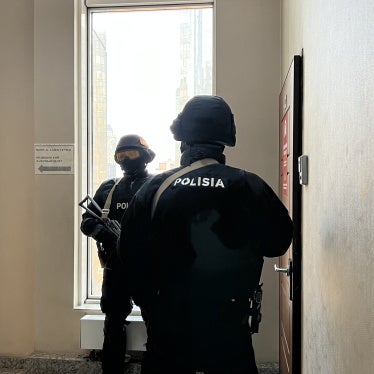 Special police force officers stand outside the Orda.kz editorial office in Almaty, Kazakhstan, during a December 1, 2025 search of the premises after authorities opened a criminal case against Gulnara Bazhkenova, the publication's editor-in-chief, for allegedly “disseminating knowingly false information."