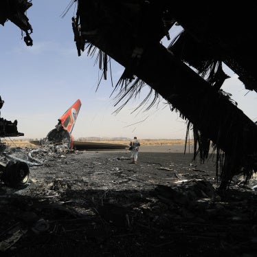 A Houthi rebel next to a destroyed plane at the Sanaa International Airport on May 7, 2025, a day after Israel's military warplanes struck Yemen's rebel-held capital Sanaa. 