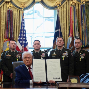 US President Donald Trump shows a signed executive order classifying fentanyl as 'weapon of mass destruction' during a Mexican Border Defense Medal presentation in the Oval Office at the White House in Washington, DC, December 15, 2025.