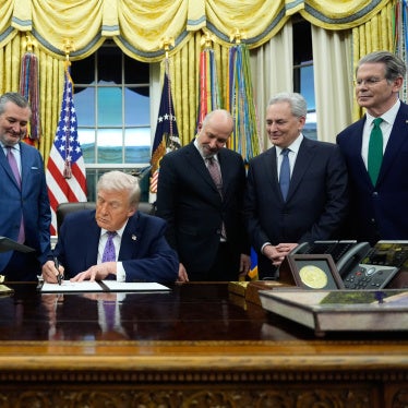 US President Donald Trump signs an Al initiative in the Oval Office of the White House, Washington DC, December 11, 2025.