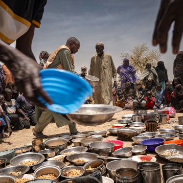 Sudanese refugees from Zamzam camp outside of El Fasher, in Darfur, receive food at an Emergency Response Room Communal Kitchen while being relocated to the Iridimi transit camp in Tine, eastern Chad, May 4, 2025. 