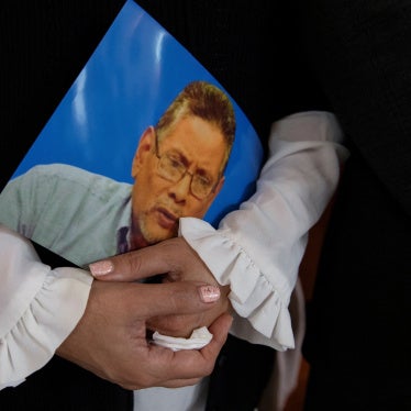 Claudia Vargas holds a photo of her husband, exiled former Nicaraguan military officer and outspoken government critic Roberto Samcam, who was shot to death in his condo on June 19, during the funeral Mass, in San Jose, Costa Rica, June 22, 2025. 