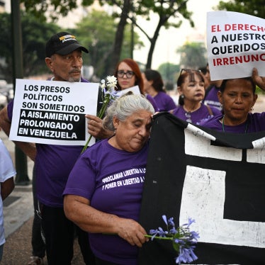 Relatives of political prisoners hold signs as they take part in a group prayer during Holy Week in Altamira Square in Caracas on April 14, 2025.