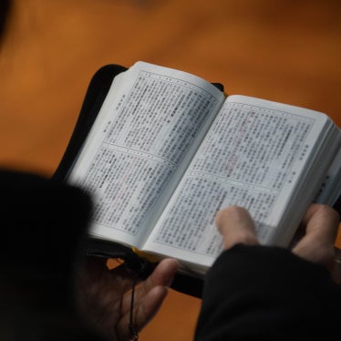 A church member reads a bible during a service in Hong Kong in solidarity with the Early Rain Covenant Church in China, whose members face persecution, December 18, 2023. 