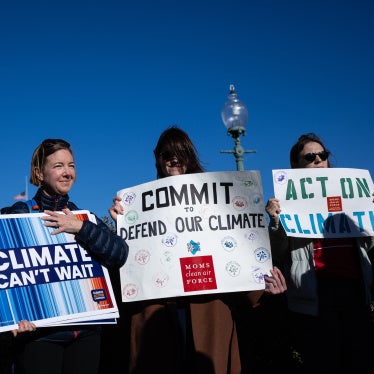 Climate activists hold signs during a press conference outside the US capitol building